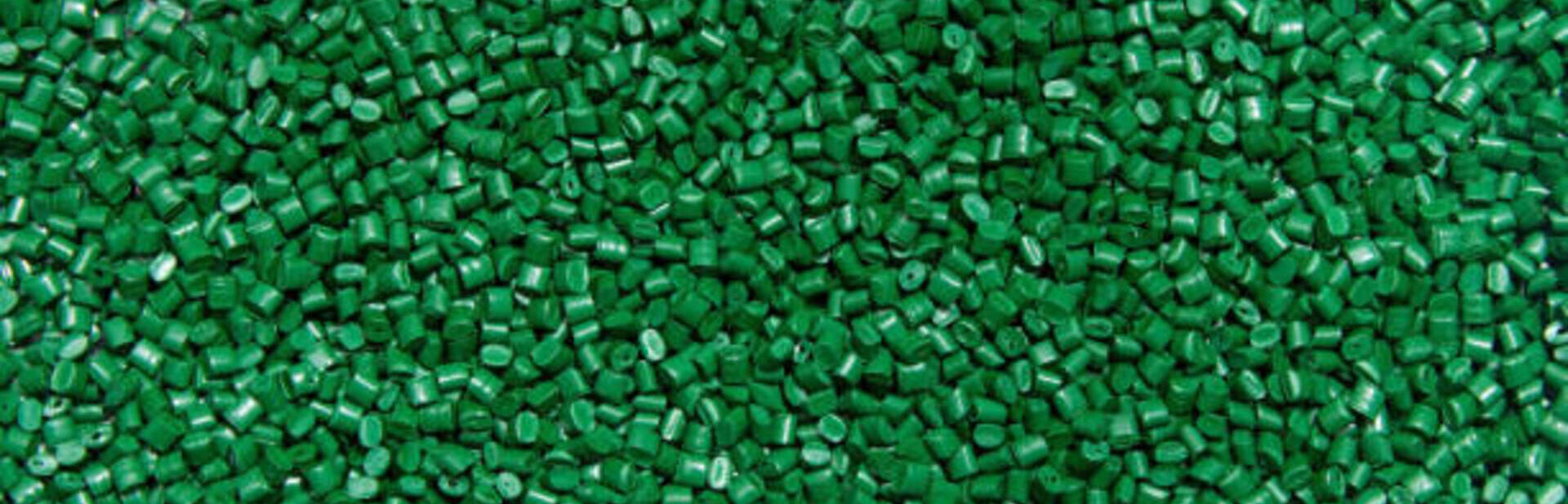 The plastic granules. Polymeric dye green for the background . Dye for plastics in granules .